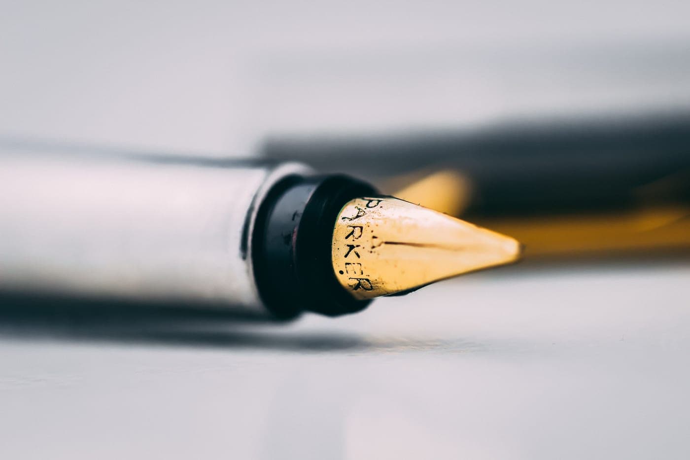 A fountain pen nib photographed close up on paper