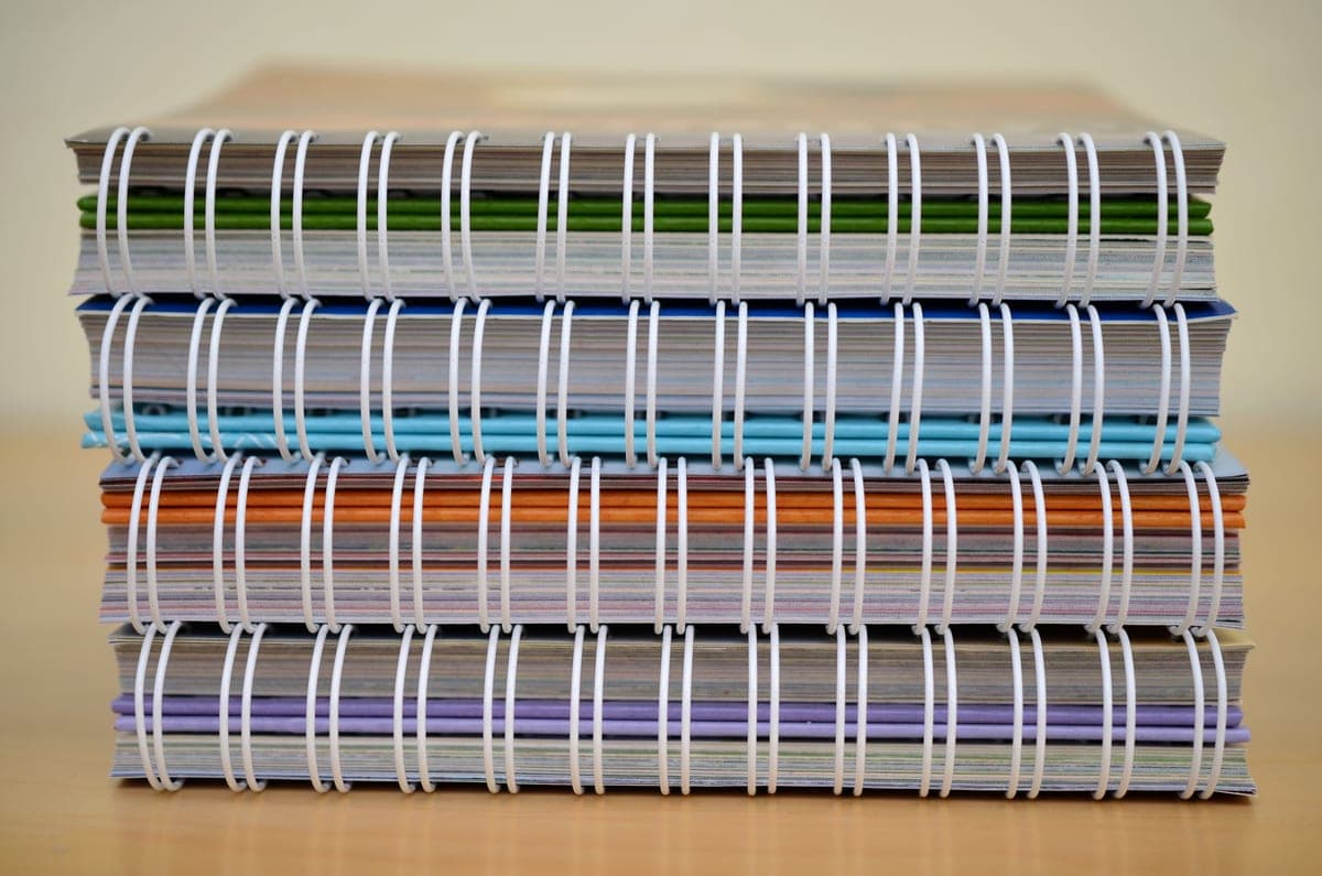 A stack of notebooks on a desk